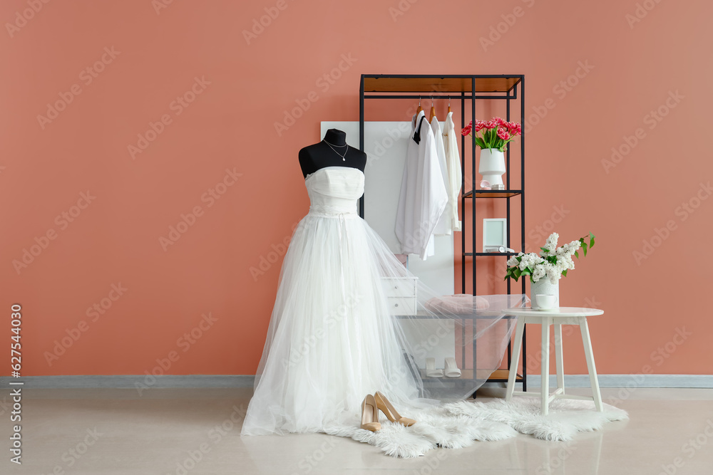 Mannequin with wedding dress and shelving unit in room