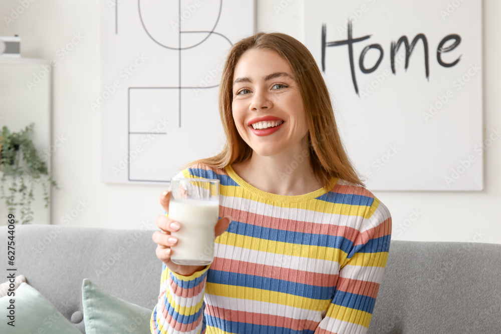 Young woman with glass of milk at home