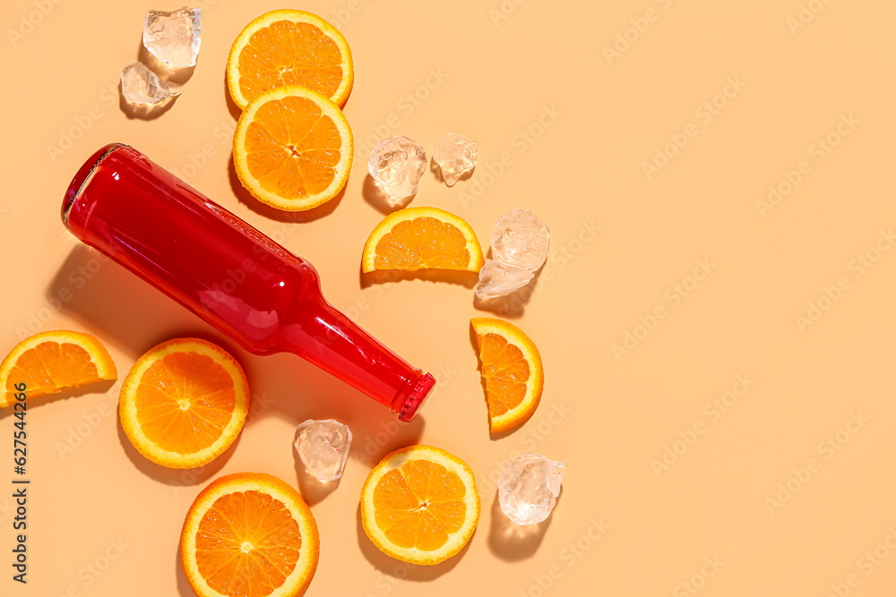 Composition with bottle of fresh soda, orange and ice on beige background