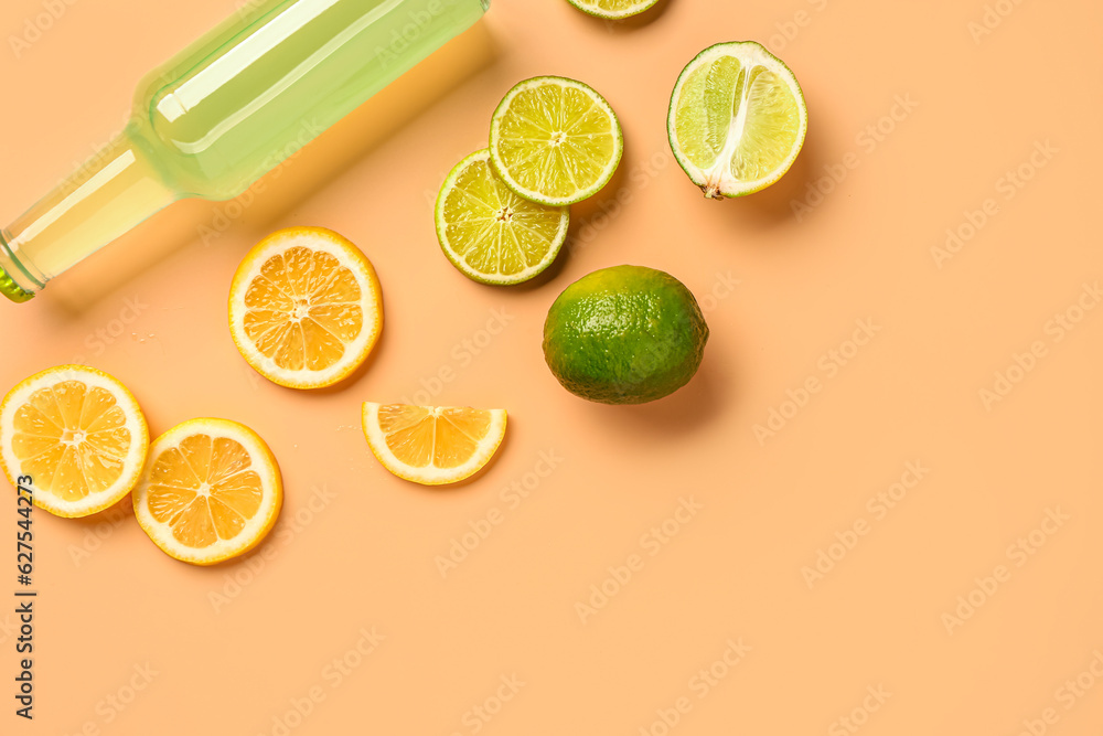 Composition with bottle of fresh soda and lime on beige background