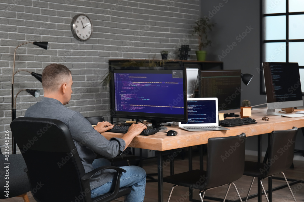 Mature male programmer working in office