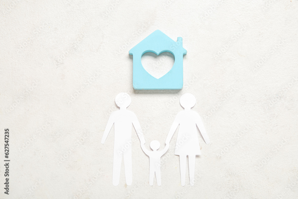 Figures of family with house on white background