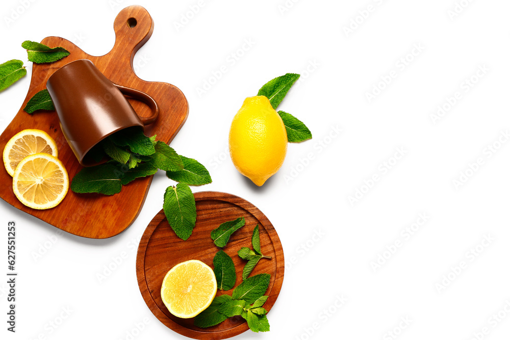 Composition with cup, fresh mint and lemons on white background