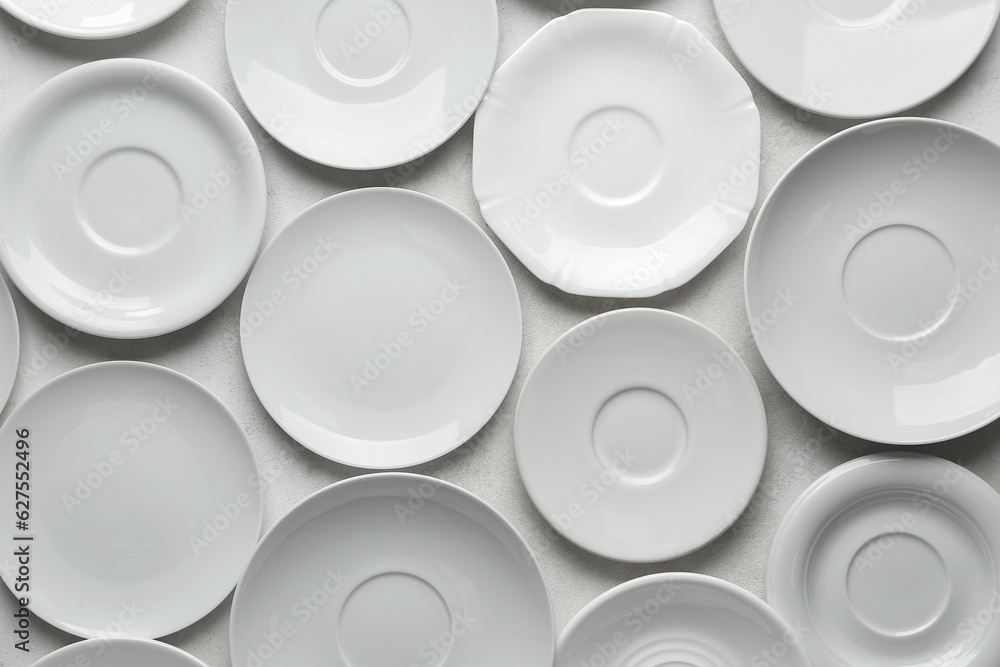 Many clean white plates on white background