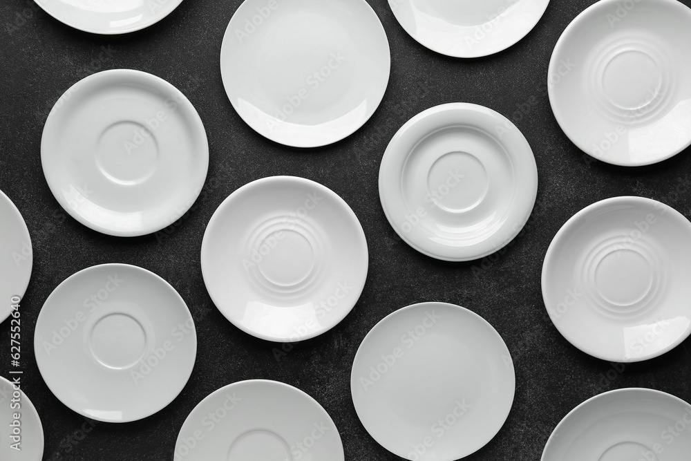 Many clean white plates on black table