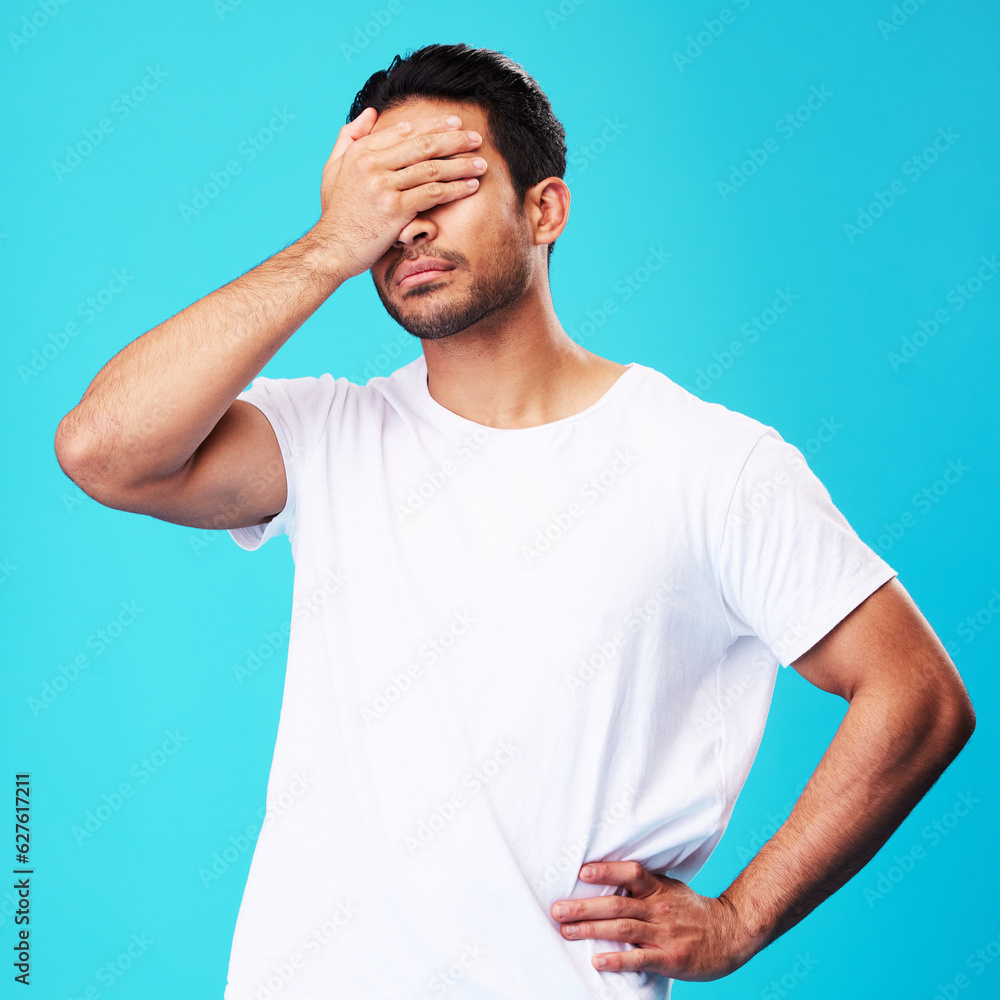 Man, face palm and mistake in studio with thinking, regret and anxiety for fail by blue background. 