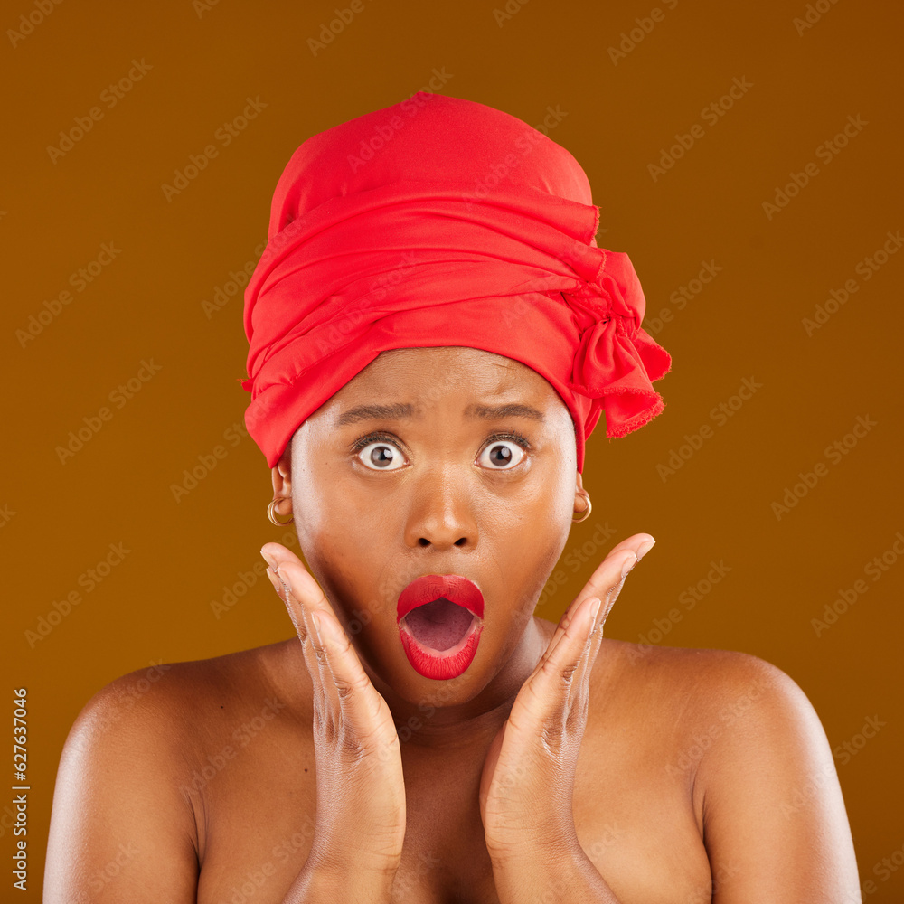 Portrait, surprise and black woman with makeup, cosmetics or head wrap against a brown studio backgr