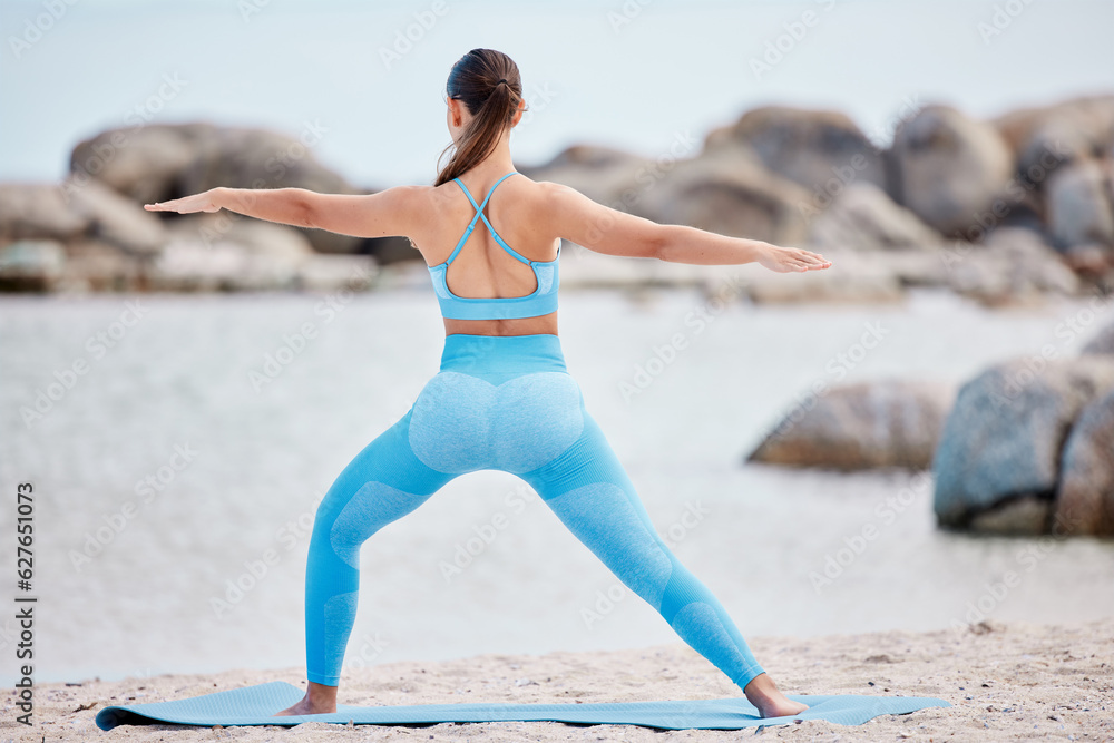 Yoga, stretching and back view of woman at the beach for workout or training as health, mindfulness 