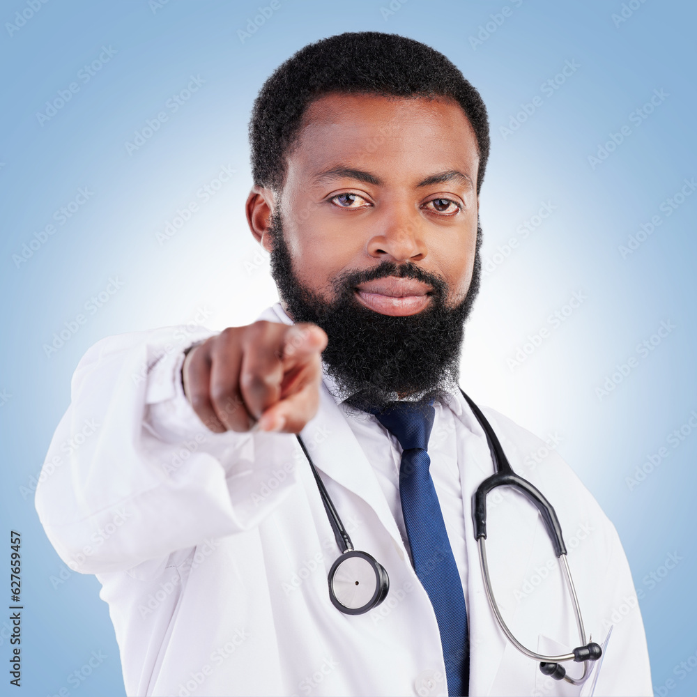 Black man, portrait and doctor pointing to you for healthcare selection against a blue studio backgr