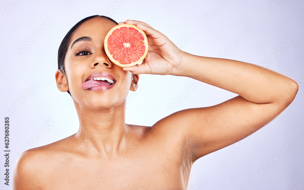 Woman, portrait and grapefruit for natural beauty, skincare or cosmetics against a studio background