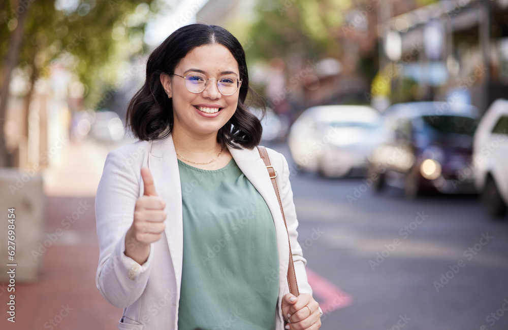 Business woman, thumbs up and portrait in the city, street or professional worker with success, agre