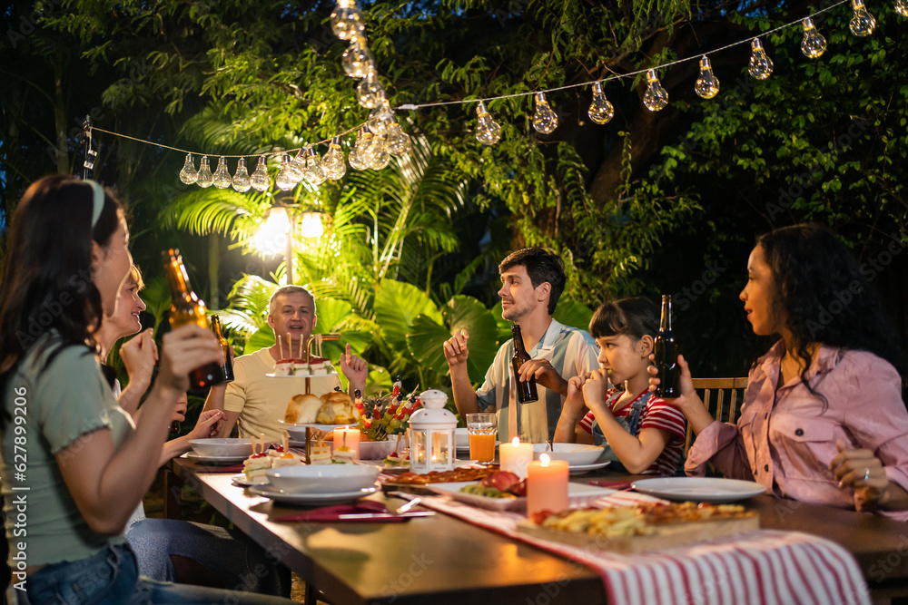 Multi-ethnic big family having fun, enjoy party outdoors in the garden. 