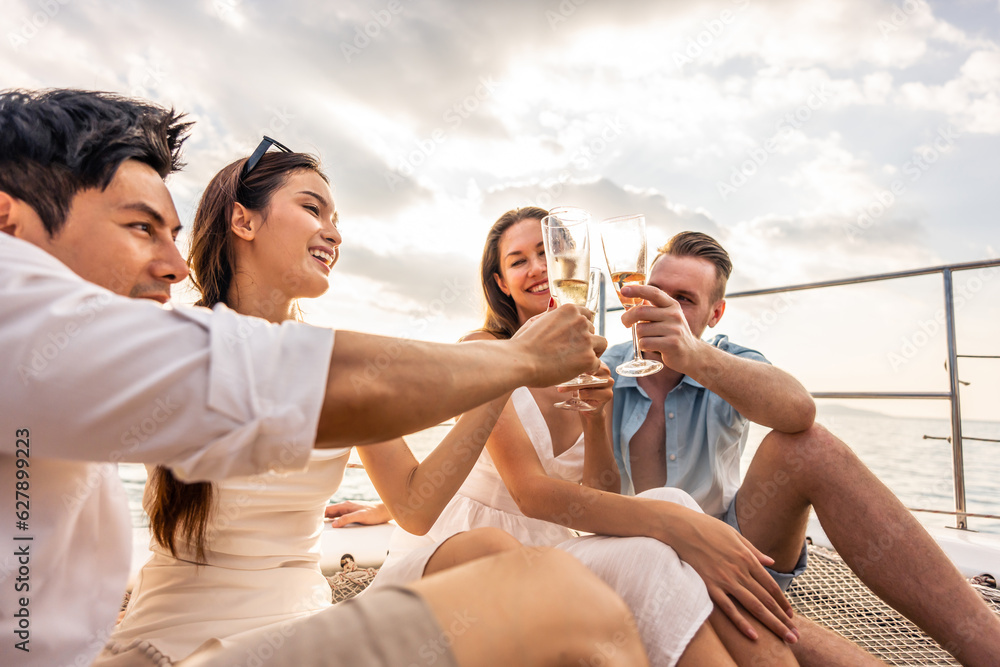 Group of diverse friends drink champagne while having a party in yacht. 