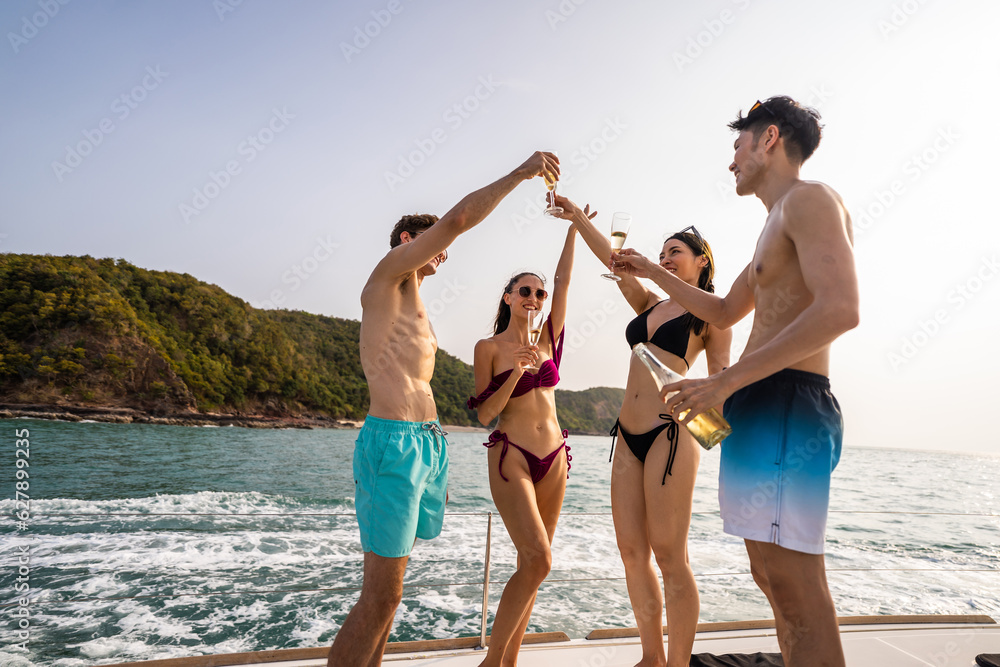 Group of diverse friends drink champagne while having a party in yacht. 