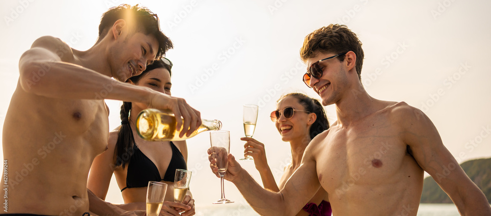 Group of diverse friends drink champagne while having a party in yacht. 