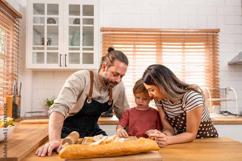 Caucasian attractive couple baking bakery with son in kitchen at home. 