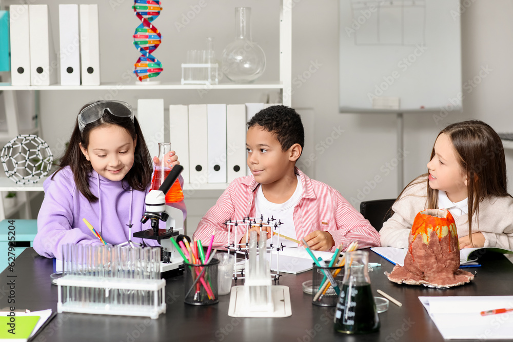 Little children studying Chemistry in science classroom