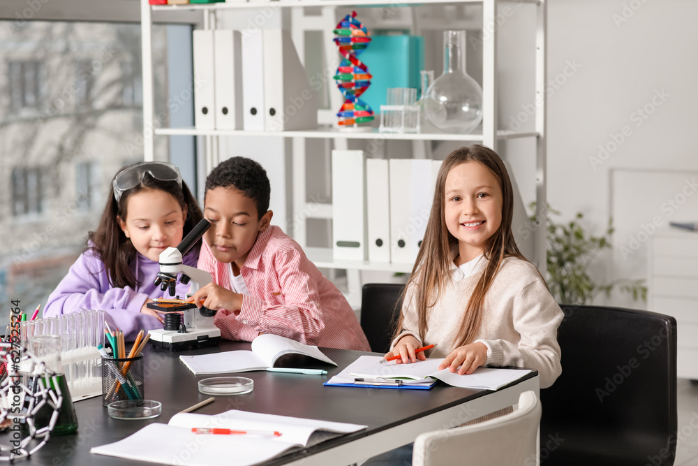 Little children with molecules studying Chemistry in science classroom