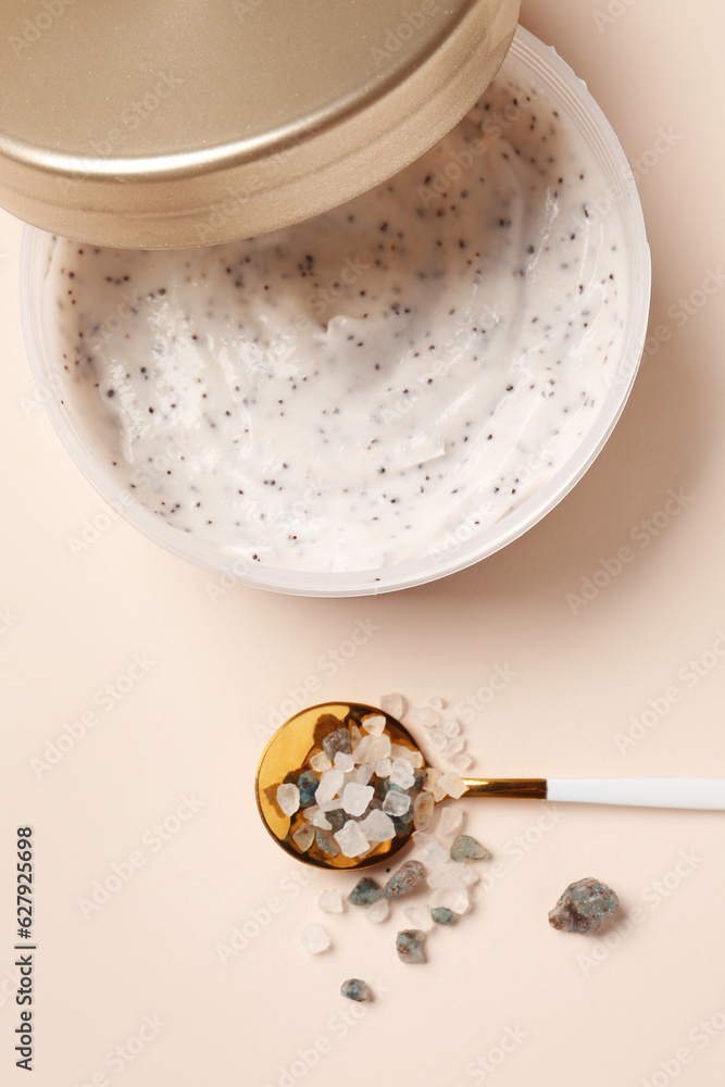 Jar of natural body scrub and sea salt on color background, closeup