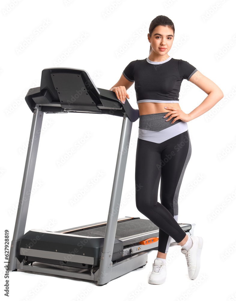 Sporty young woman with treadmill on white background