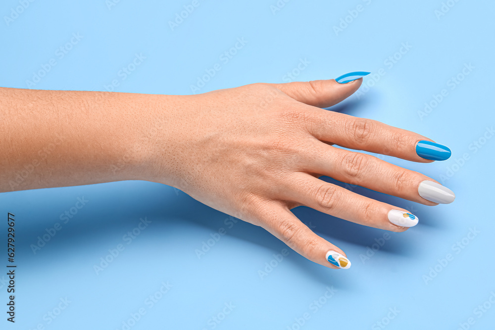 Woman with press-on nails on blue background