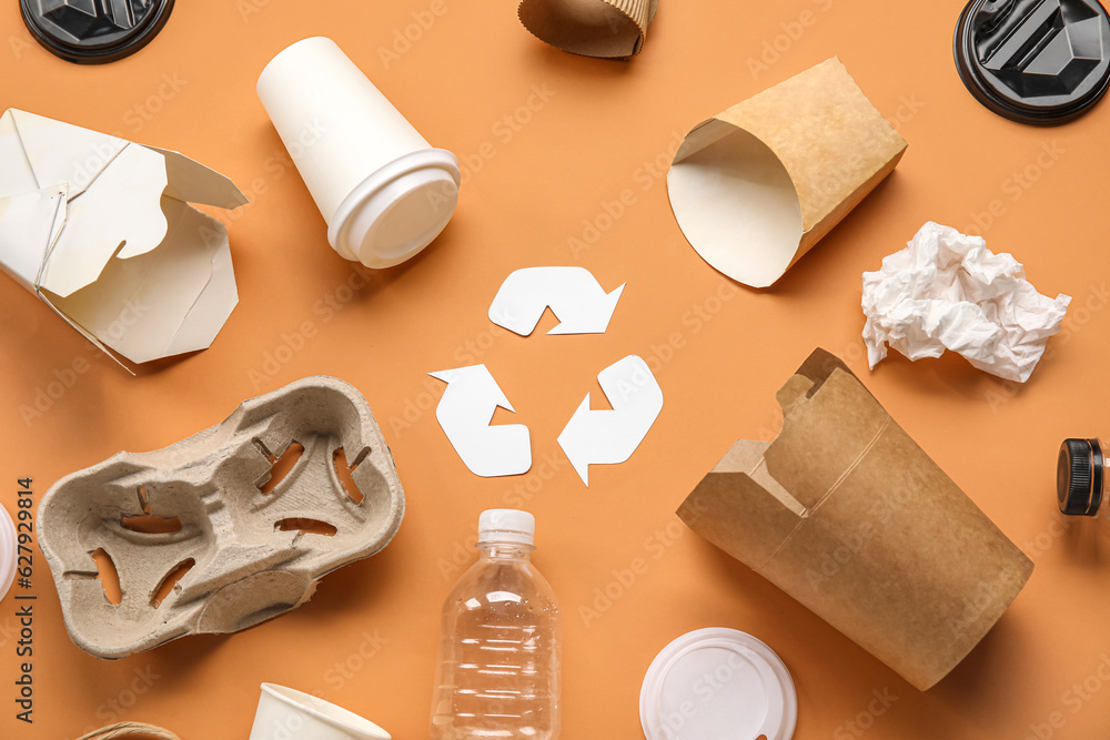 Recycling sign with garbage on orange background