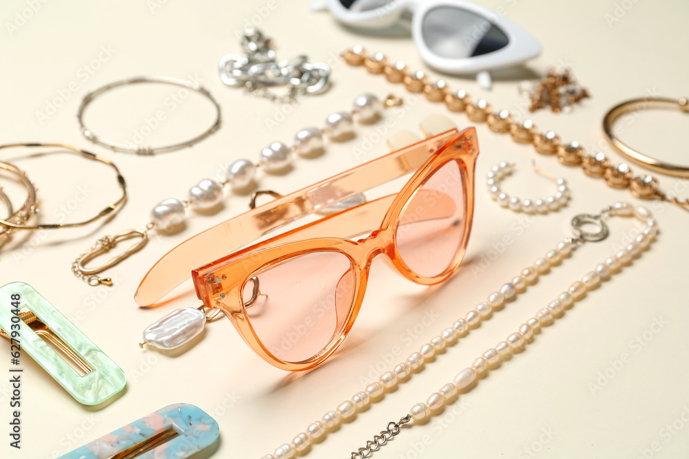 Stylish accessories with sunglasses on light background, closeup