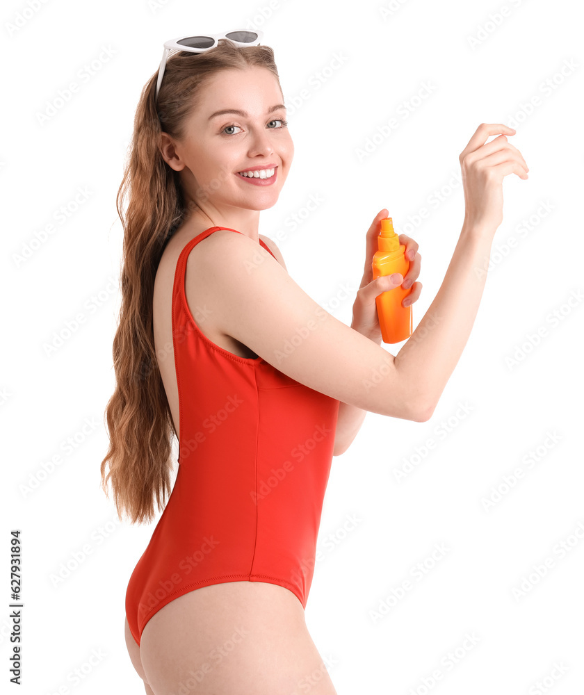 Beautiful young woman applying sunscreen cream on white background