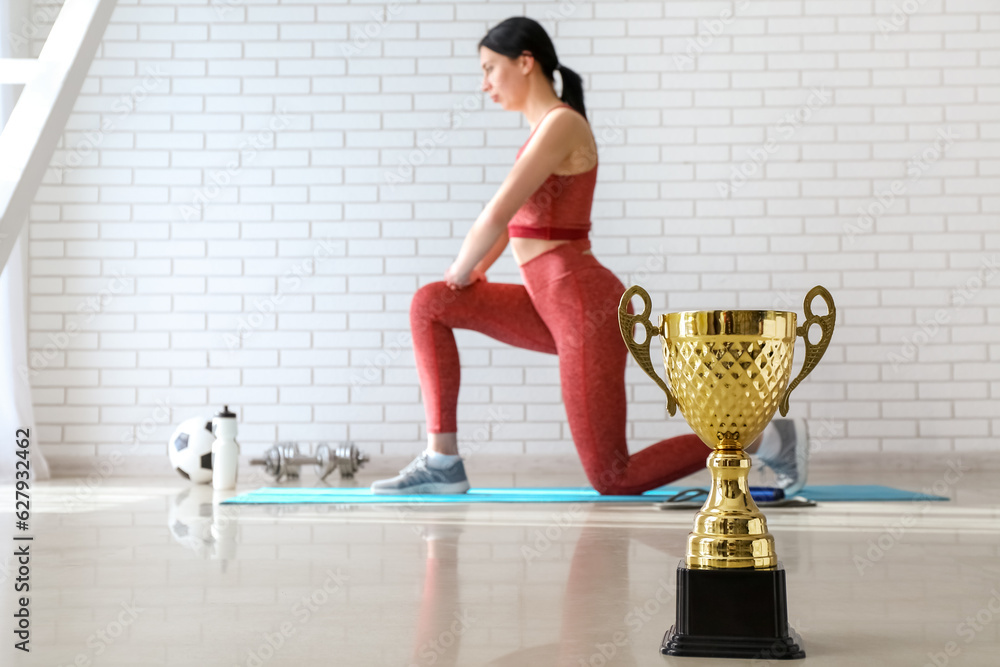 Gold cup on floor in gym, closeup