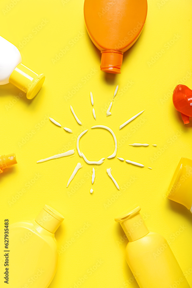 Drawing of sun made with sunscreen cream on yellow background