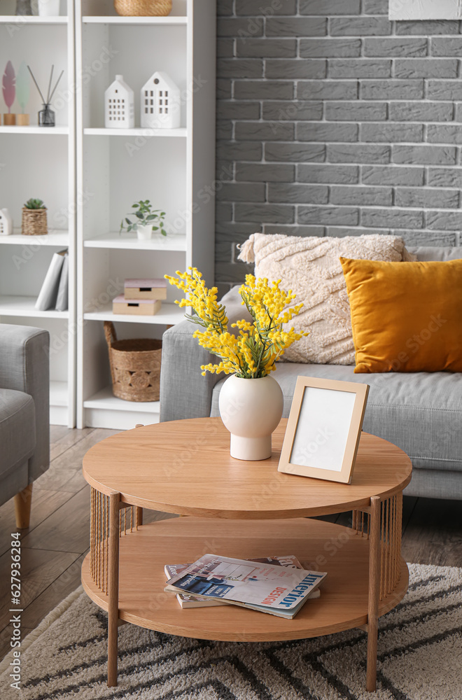 Interior of modern living room with sofa, coffee table and shelving unit