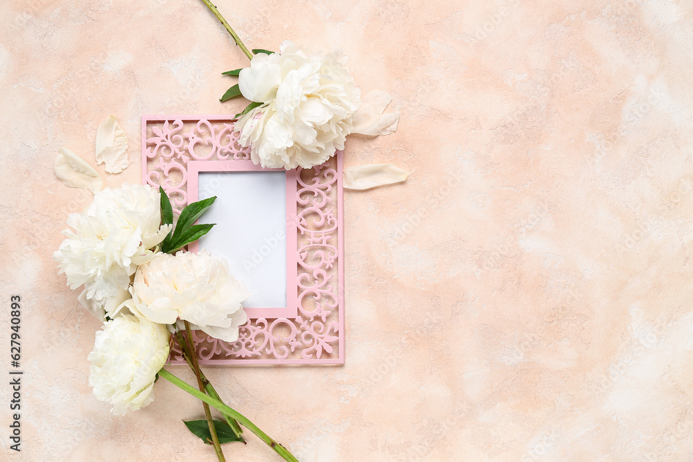 Composition with blank picture frame and beautiful peony flowers on color background