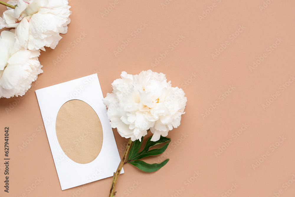 Composition with blank card and beautiful peony flowers on color background