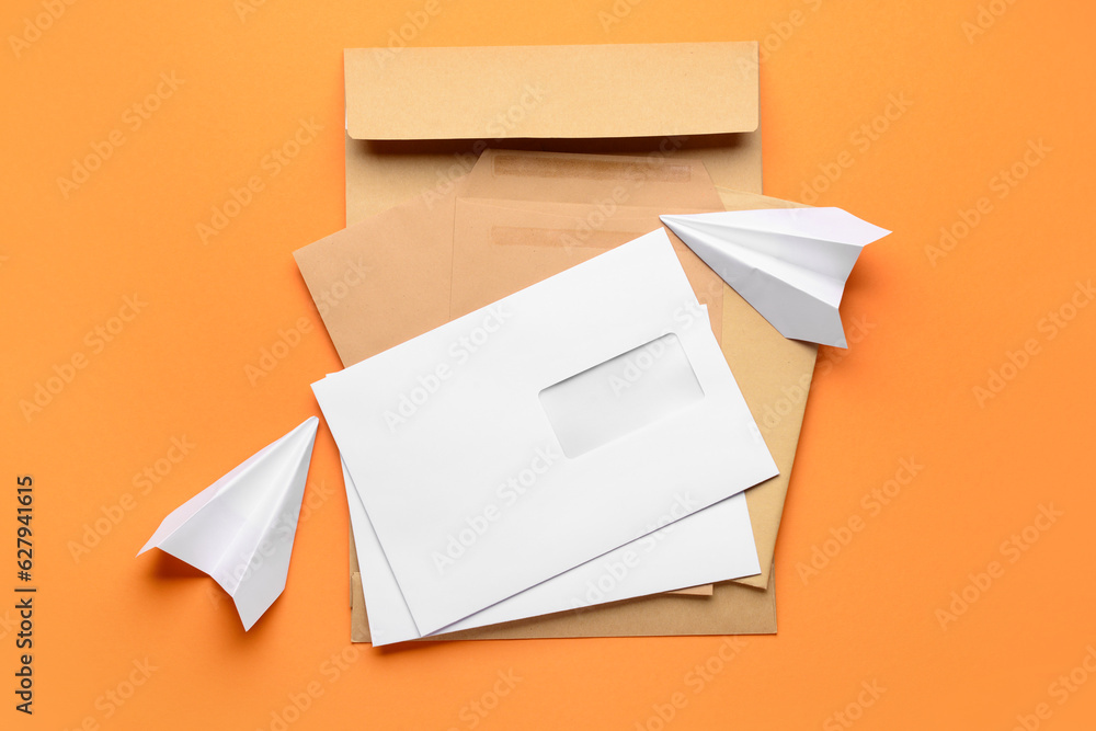 Different envelopes and paper planes on color background