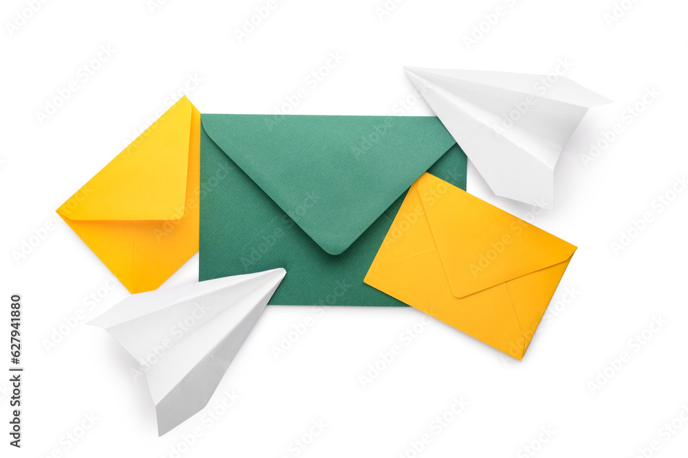 Envelopes with card and paper planes on white background