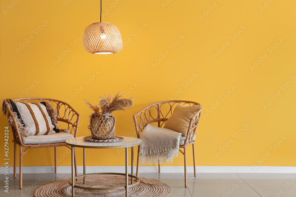 Interior of stylish room with glowing ceiling lamp, table and chairs