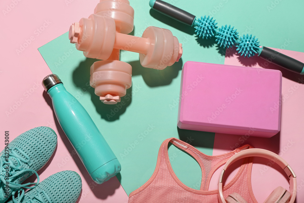 Composition with bottle of water, sports equipment and clothes on color background