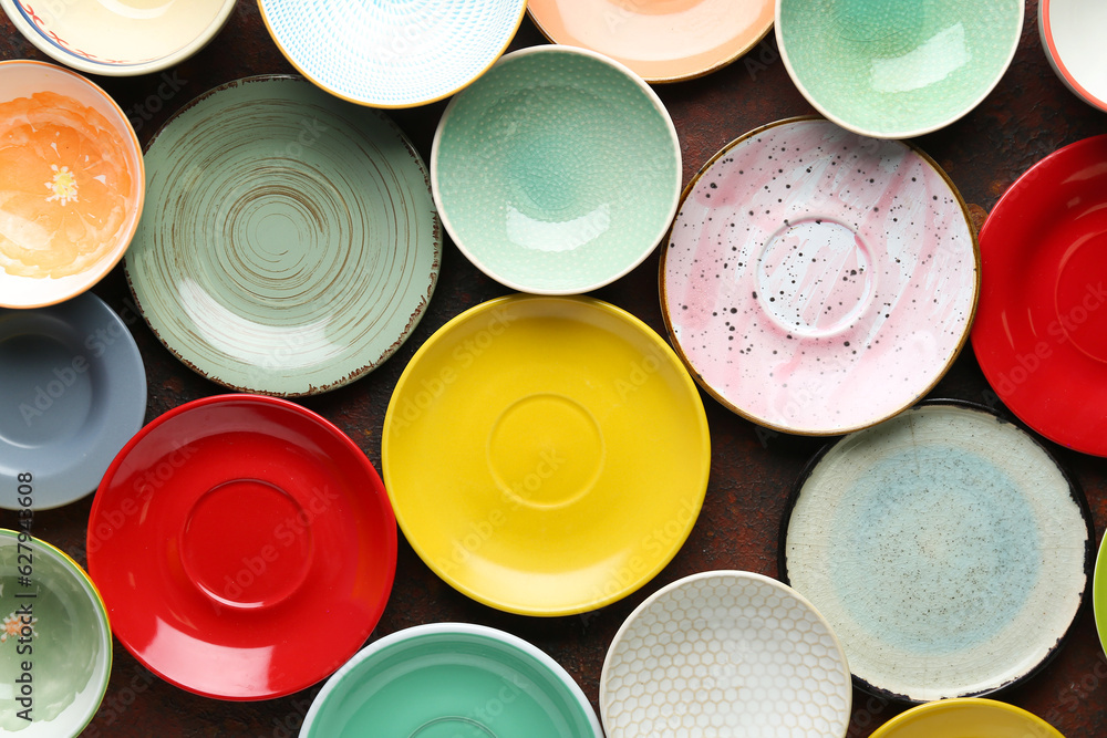 Set of colorful clean plates on brown background