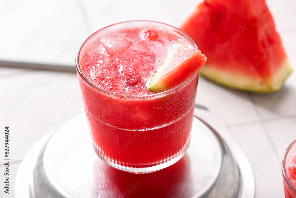 Glass of tasty watermelon fresh on white tile background