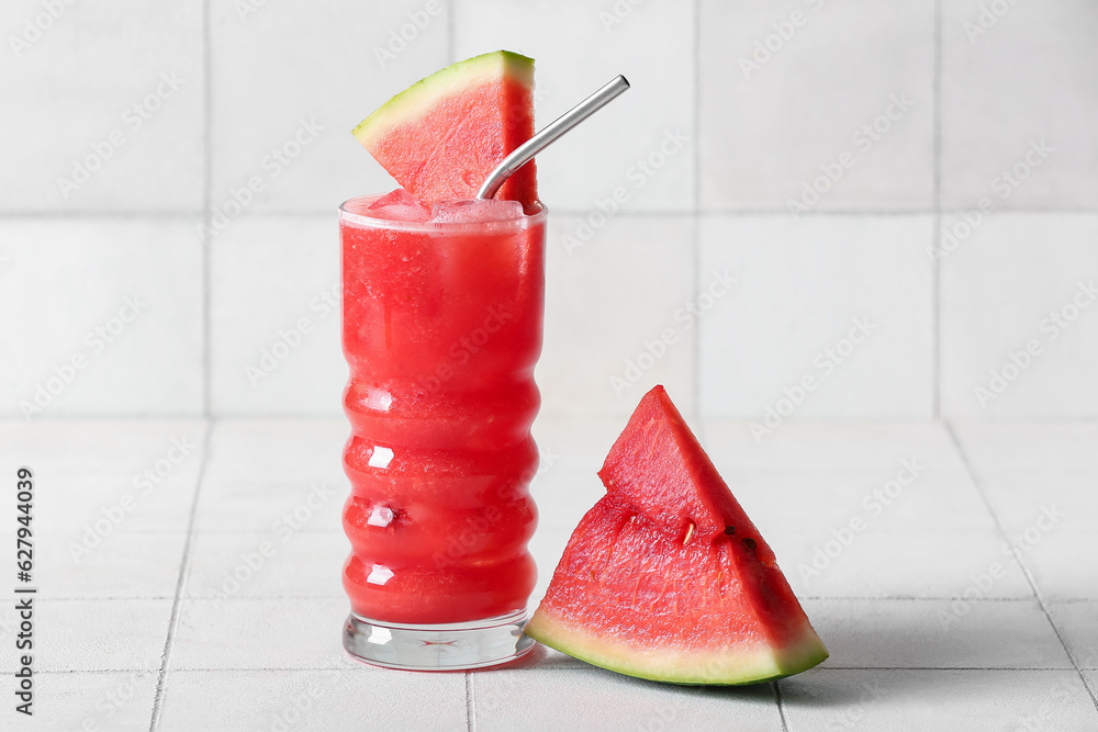 Glass of tasty watermelon fresh on white tile background