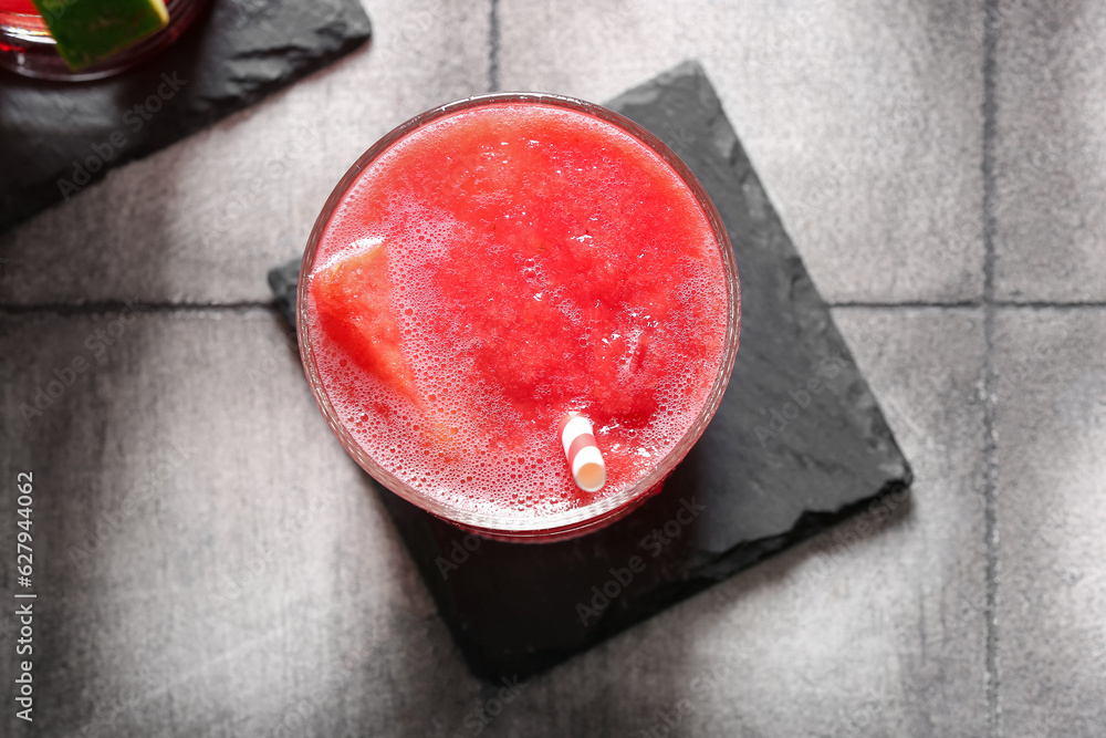 Glass of tasty watermelon fresh on grey tile background