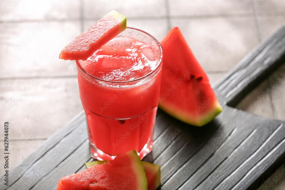 Glass of tasty watermelon fresh on grey tile background