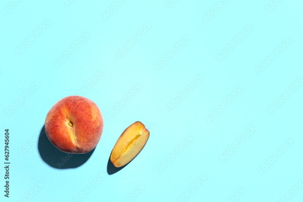 Sweet peaches on blue background