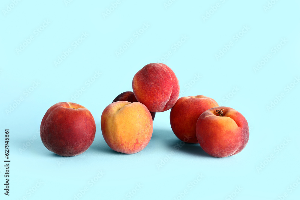 Sweet peaches on blue background