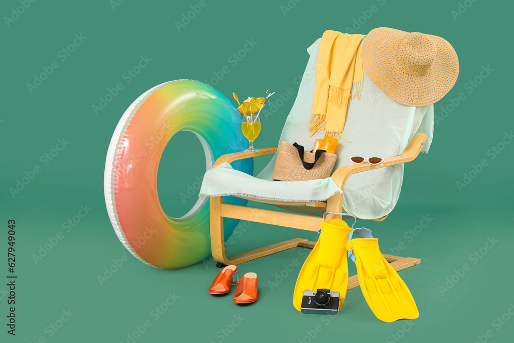 Deckchair, beach accessories, photo camera and glass of cocktail on color background