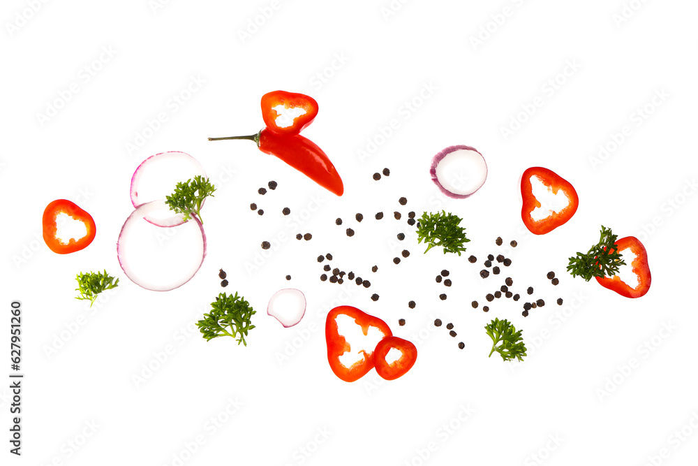 Flying peppercorns, chili pepper, parsley and onion on white background