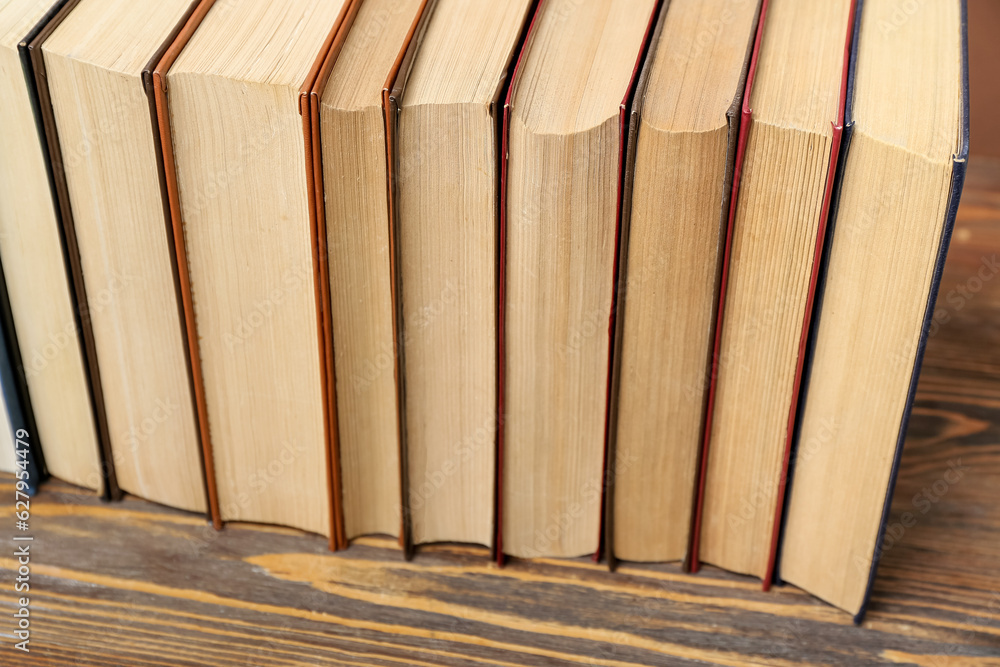 Row of books on wooden table