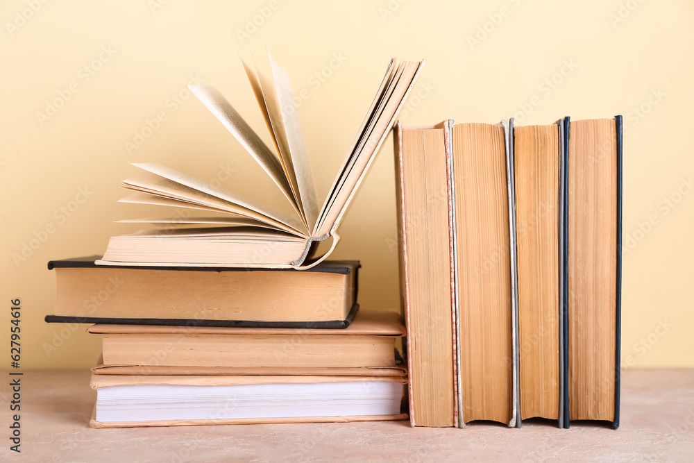 Books on table against beige background