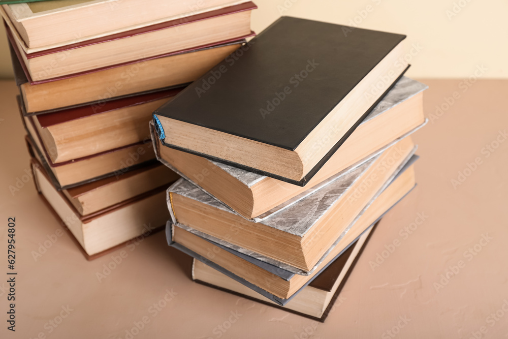 Stacks of books on beige table