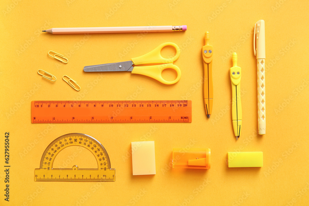 Different school stationery on orange background